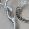 double trunk twists off into two with closeup of moon beside it